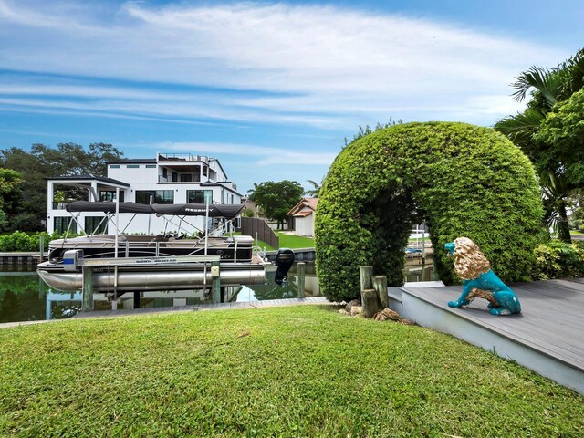 dock area featuring a lawn and a water view