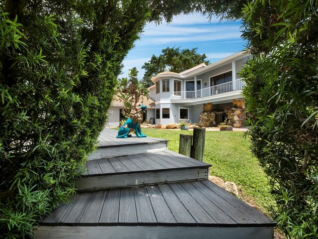 wooden terrace featuring a lawn