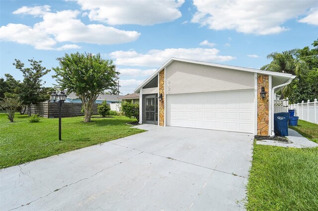 ranch-style house featuring a garage and a front yard