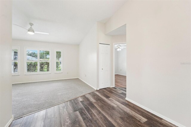 spare room with dark wood-type flooring, ceiling fan, and vaulted ceiling