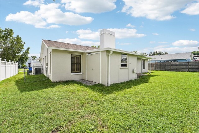 rear view of property featuring a yard