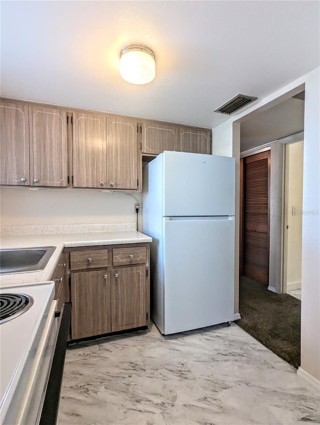 kitchen featuring sink and white appliances