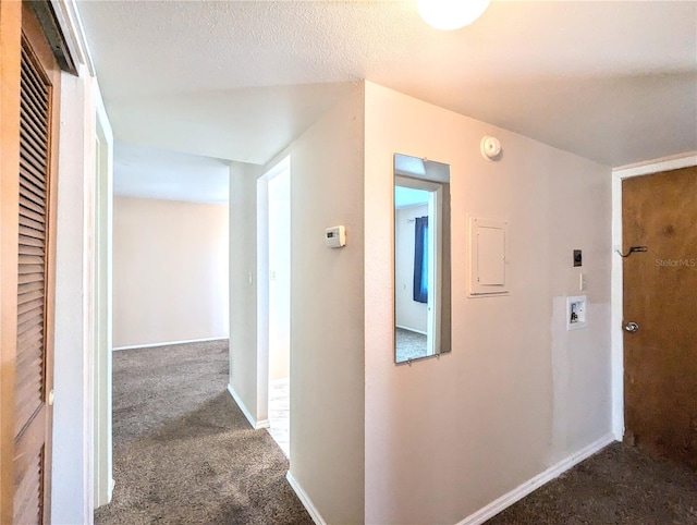 hall featuring a textured ceiling and carpet floors