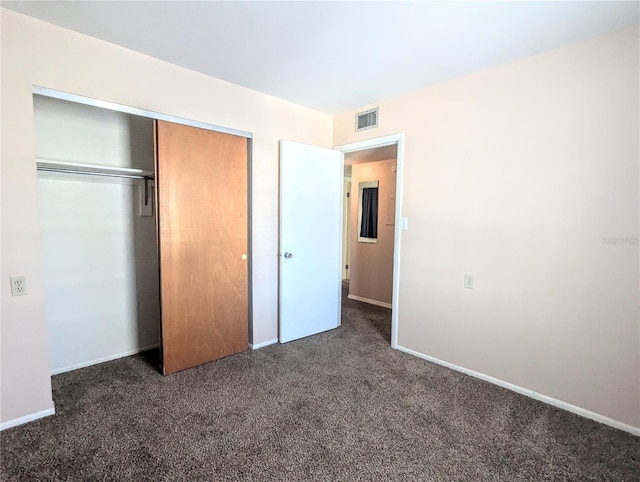 unfurnished bedroom featuring a closet and carpet flooring