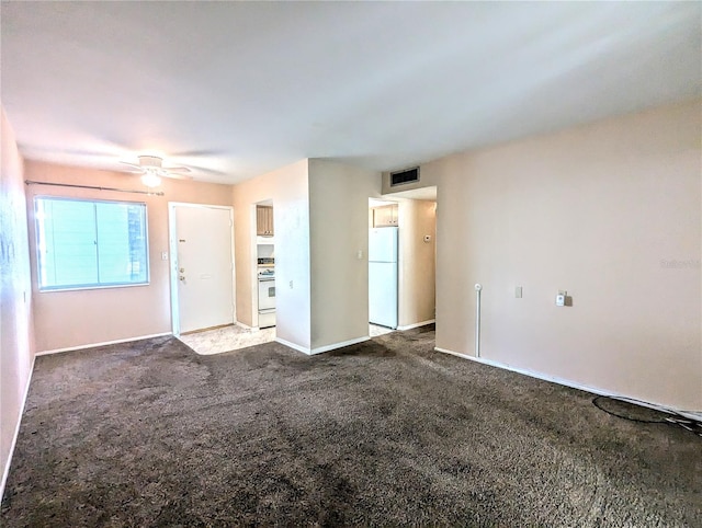 unfurnished living room featuring ceiling fan and carpet flooring