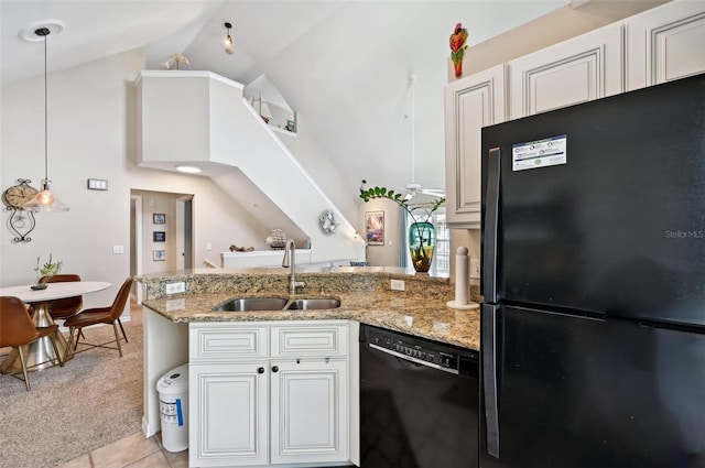 kitchen with black appliances, light stone counters, sink, and white cabinets