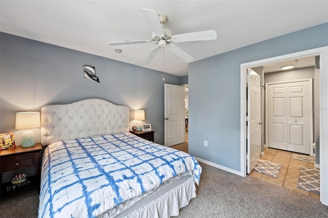 bedroom with a closet, ceiling fan, and light carpet