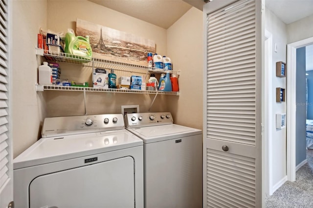 laundry area with separate washer and dryer and light carpet