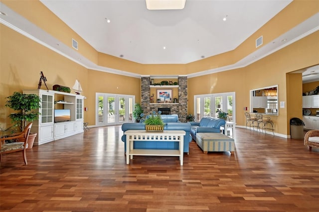 living room featuring plenty of natural light, dark hardwood / wood-style floors, and french doors