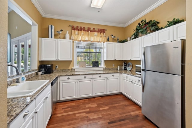 kitchen featuring appliances with stainless steel finishes, a wealth of natural light, and hardwood / wood-style flooring