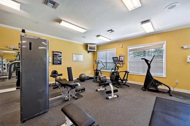 exercise room with a textured ceiling and ornamental molding