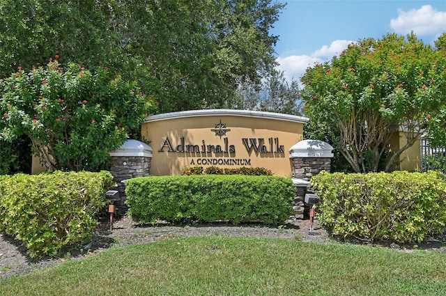 community sign featuring a lawn