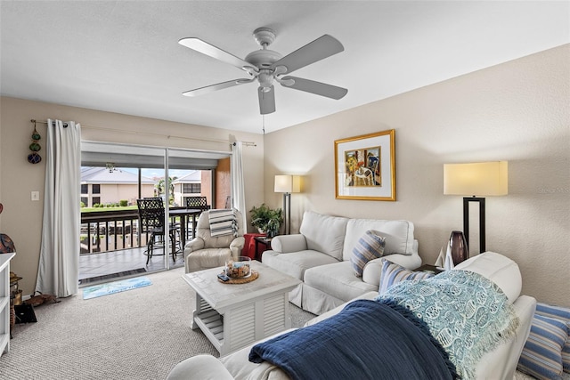 carpeted living room featuring ceiling fan