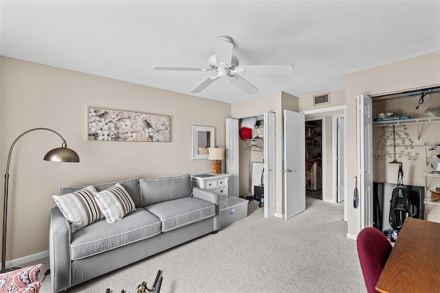 living room featuring light colored carpet and ceiling fan