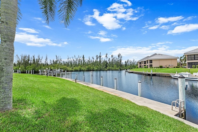 view of dock with a water view and a yard