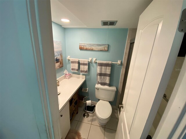 bathroom featuring vanity, toilet, an enclosed shower, and tile patterned flooring