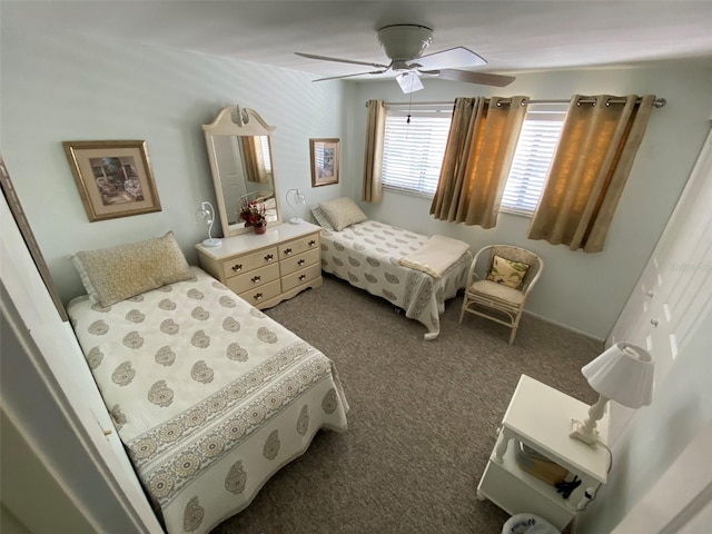 bedroom featuring ceiling fan and carpet