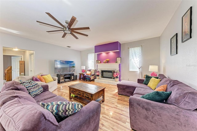 living room with ceiling fan and light hardwood / wood-style flooring