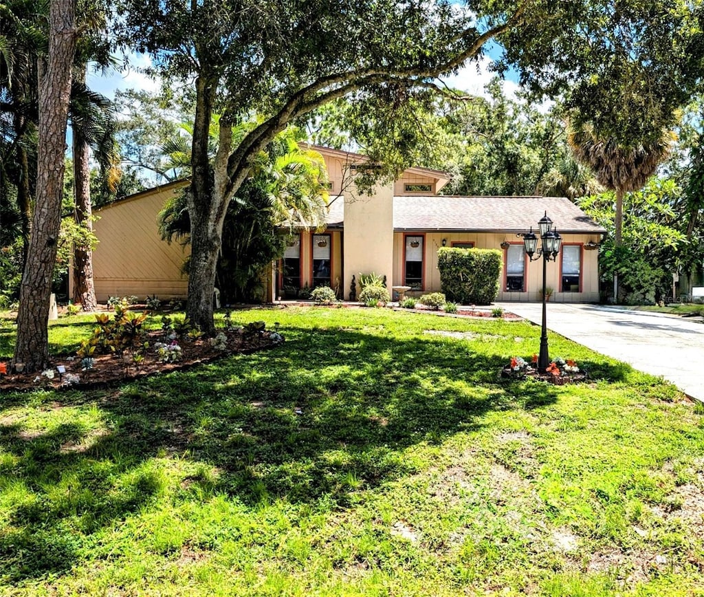 view of front of house with a garage and a front lawn