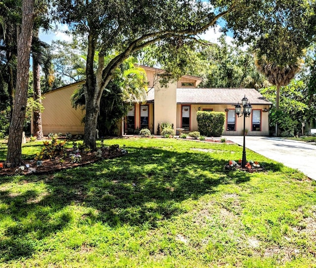 view of front of house with a garage and a front lawn