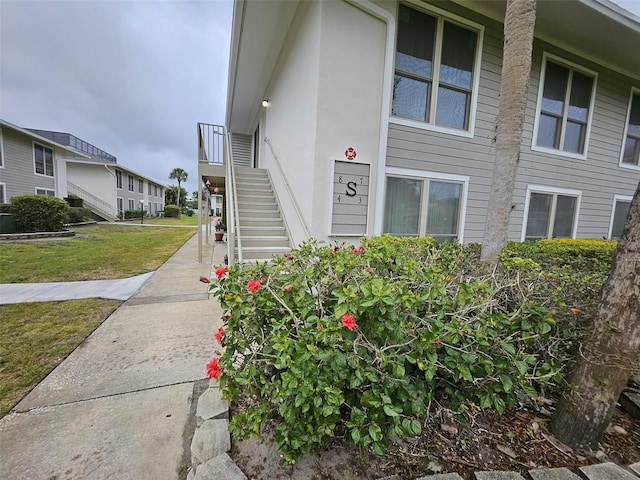 property entrance with a lawn