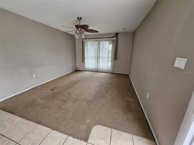 tiled empty room with ceiling fan