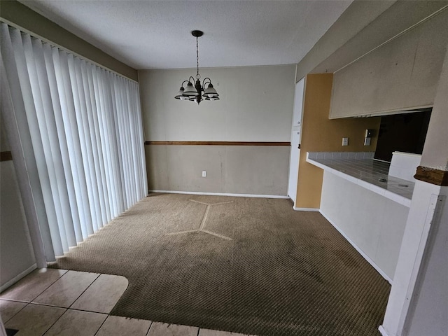 unfurnished dining area featuring a notable chandelier