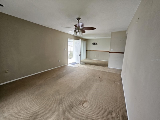 unfurnished living room with ceiling fan, light colored carpet, and a textured ceiling