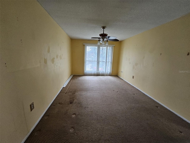 unfurnished room with carpet flooring, ceiling fan, and a textured ceiling