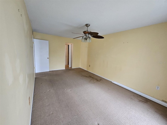 spare room featuring carpet flooring and ceiling fan