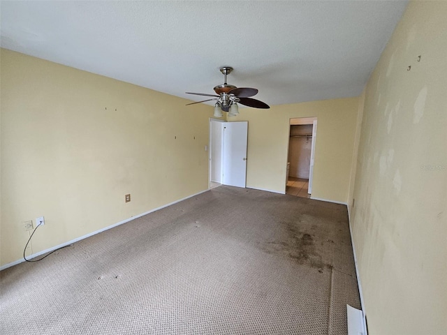 unfurnished room with carpet flooring and ceiling fan