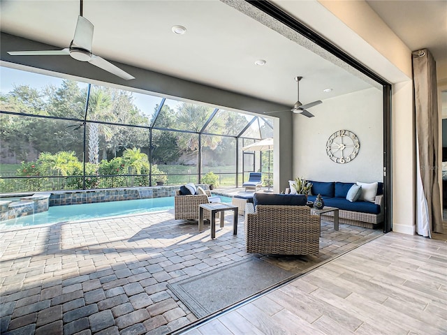 view of patio / terrace featuring a lanai, ceiling fan, and outdoor lounge area