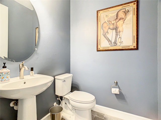 bathroom with toilet and tile patterned floors