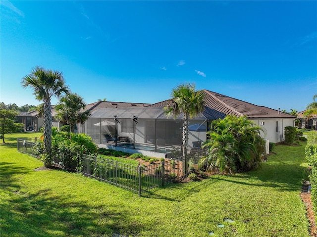 back of house featuring a yard and a lanai