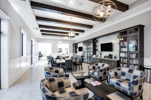 living room featuring crown molding, a notable chandelier, beam ceiling, and light tile patterned flooring