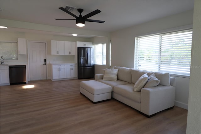 living room with wood-type flooring and ceiling fan