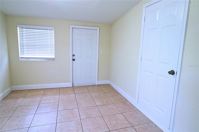 interior space featuring a textured ceiling and light tile patterned flooring