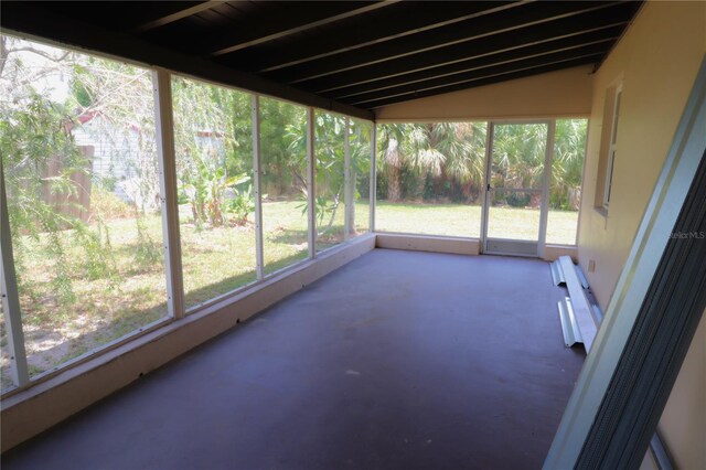 unfurnished sunroom featuring lofted ceiling