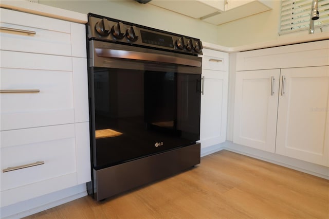 interior space featuring light hardwood / wood-style floors, white cabinets, and appliances with stainless steel finishes