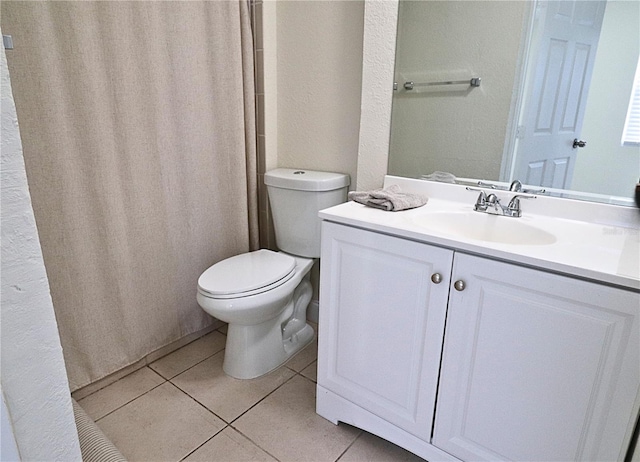 bathroom featuring vanity, toilet, and tile patterned floors