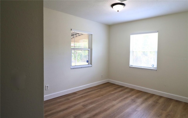 empty room featuring dark hardwood / wood-style flooring