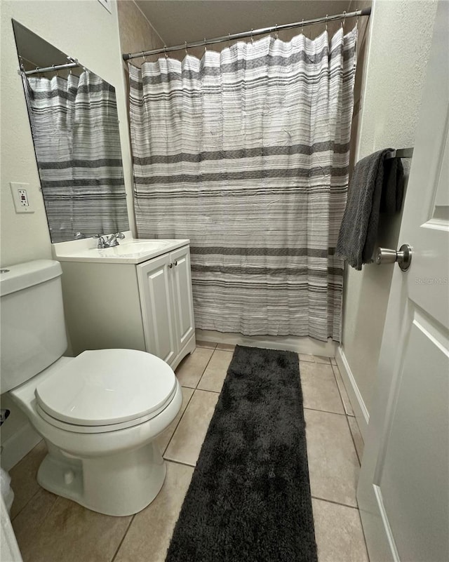 bathroom with vanity, toilet, tile patterned flooring, and a shower with shower curtain