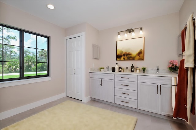 bathroom with tile patterned flooring and vanity