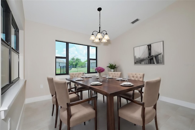 dining room featuring a chandelier, visible vents, lofted ceiling, and baseboards