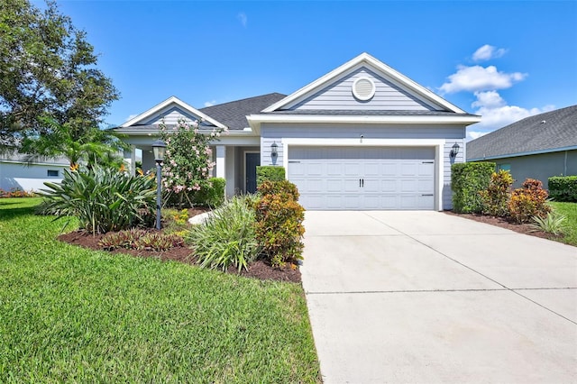 view of front of property featuring a garage and a front lawn