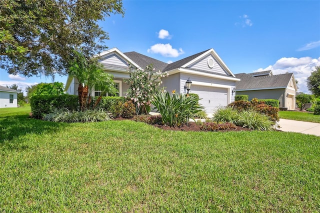 view of front of property featuring a garage and a front lawn