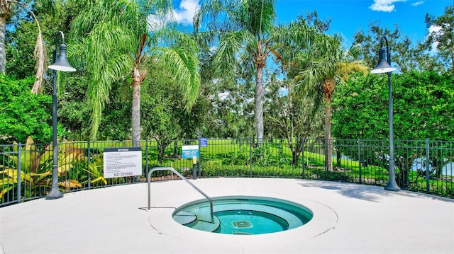 view of swimming pool featuring a community hot tub