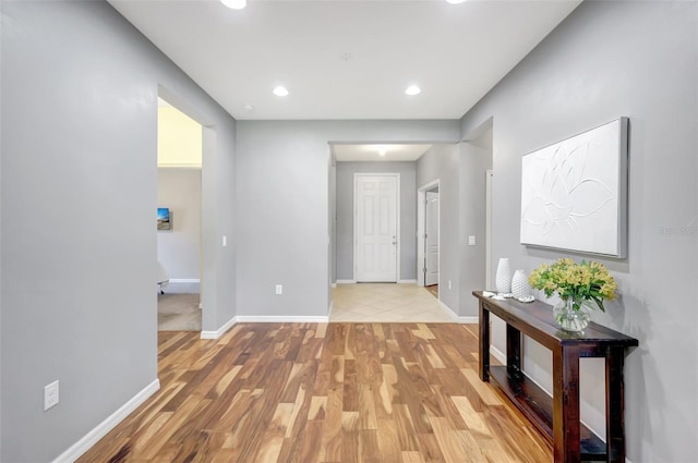 hallway with light hardwood / wood-style flooring