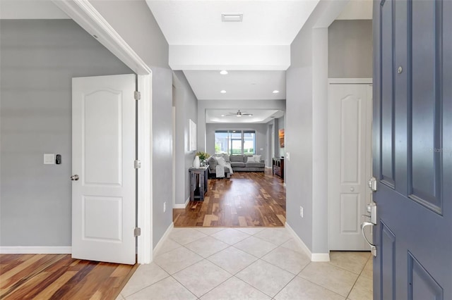 entryway featuring ceiling fan and light tile patterned floors