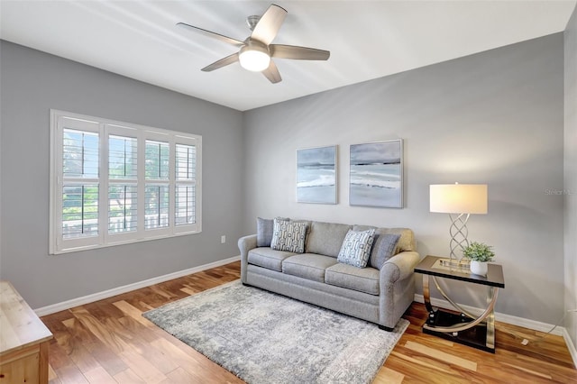 living room with hardwood / wood-style floors and ceiling fan